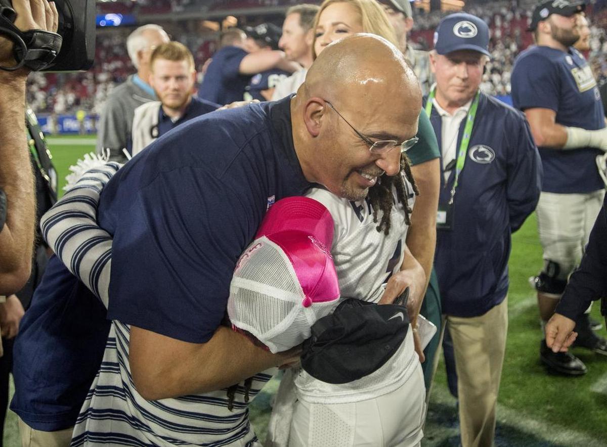 Penn State football coach James Franklin is hugged by his daughters after winning the 2017 Fiesta Bowl on Saturday, December 30, 2017 at University of Phoenix Stadium. The Nittany Lions beat Washington, 35-28.