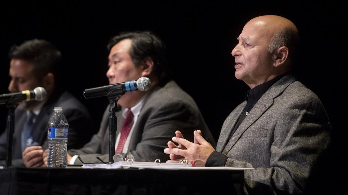Ron Madrid answers a question during the State College borough mayor debate at the State Theatre on Tuesday.