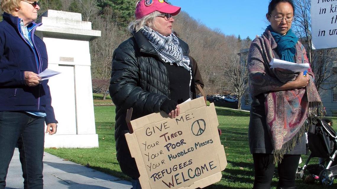 Crystal Zevon, center, attends a rally Friday in Montpelier, Vt., to support bringing Syrian refugees to the state.
