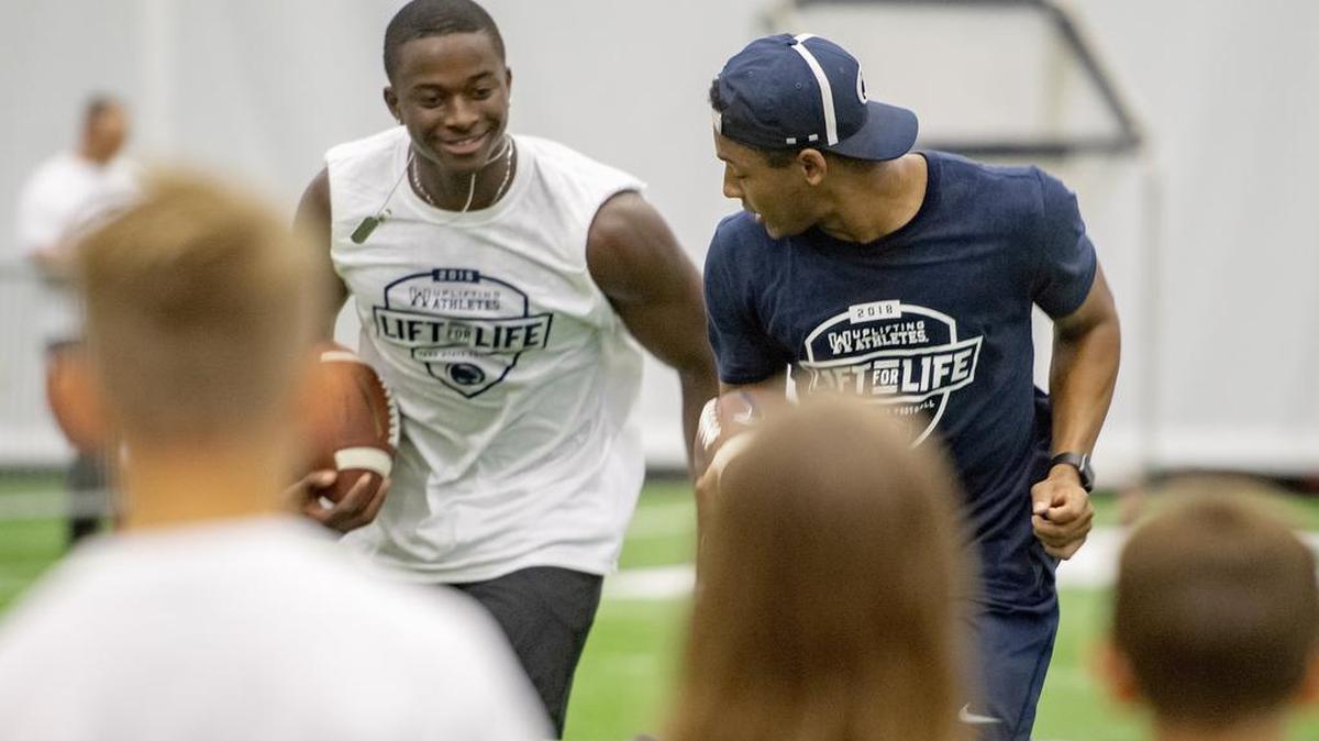 Penn State freshman Justin Shorter and Isaiah Humphries show a drill sa they help with the kids clinic during the annual Lift For Life at Holuba Hall on Saturday, June 30, 2018.
