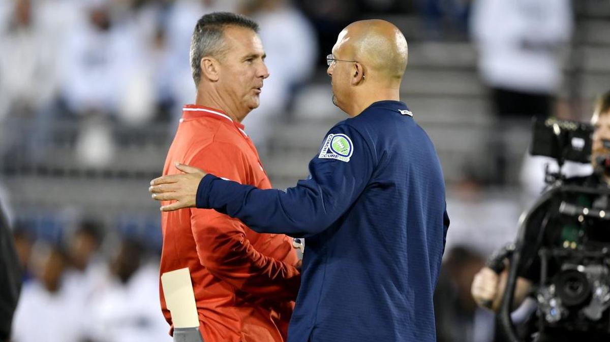 Ohio State coach Urban Meyer and Penn State football coach James Franklin greet each other as their teams warm up for the game on Saturday, Sept. 29, 2018.