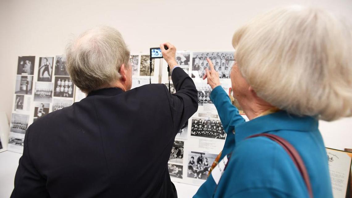 Lee Wolfe and Betsey Bloom look at old photos of his Penns Valley years Sunday.