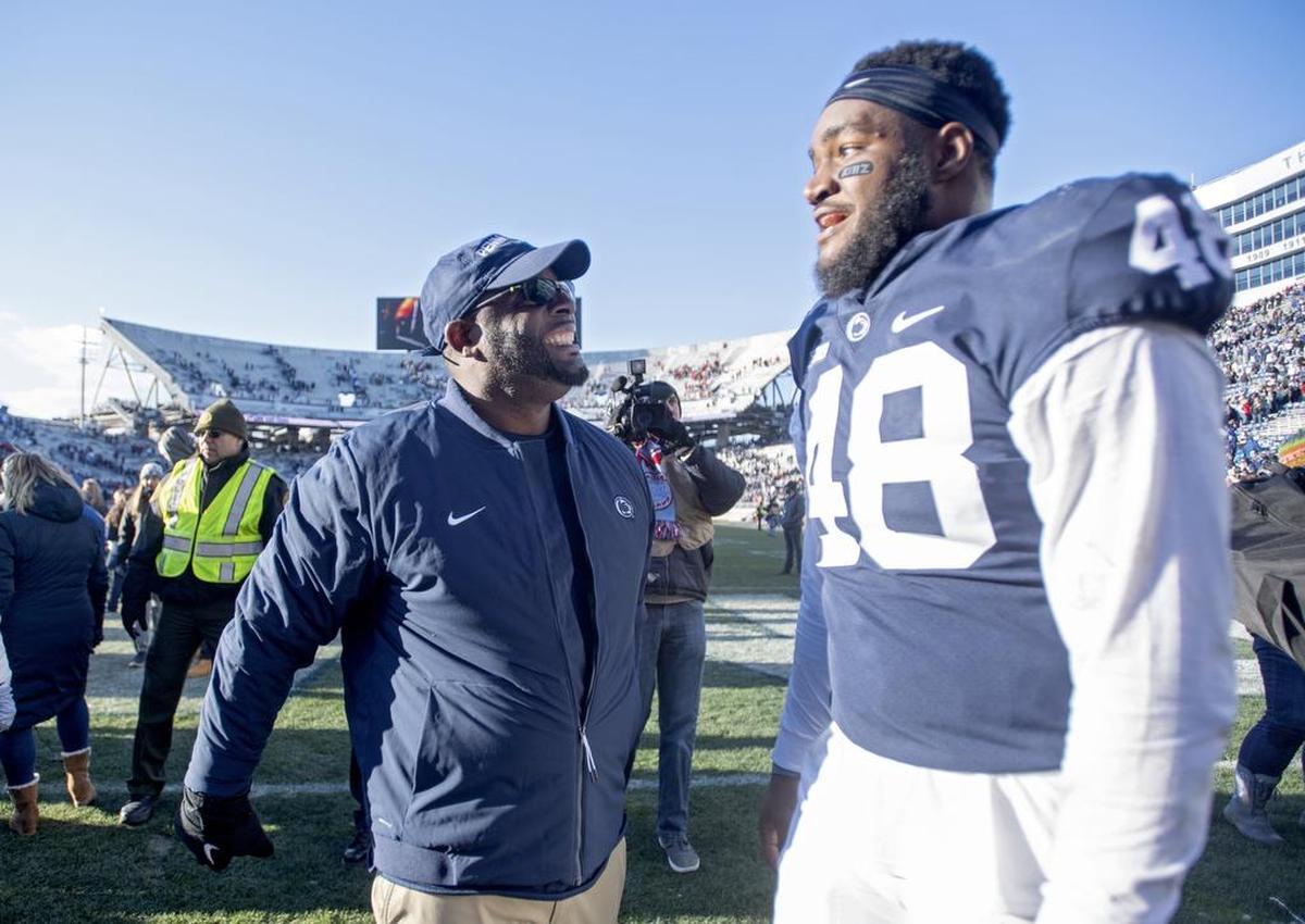 Penn State defensive line coach Sean Spencer congratulate defensive end Shareef Miller after the win over Wisconsin on Saturday, Nov. 10, 2018.