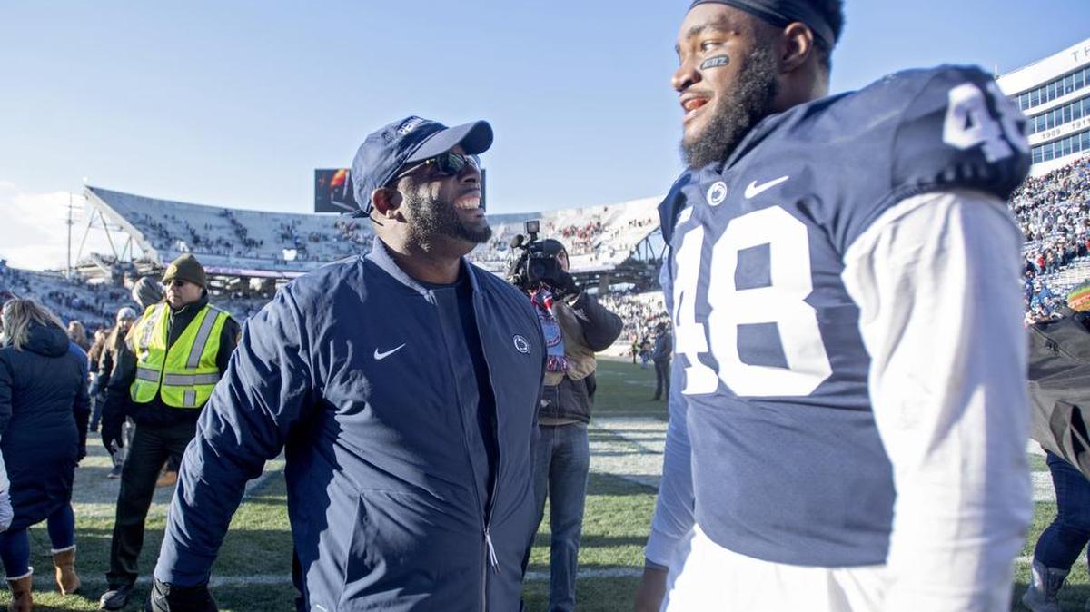 Penn State defensive line coach Sean Spencer congratulates defensive end Shareef Miller after the win over Wisconsin on Saturday, Nov. 10, 2018.