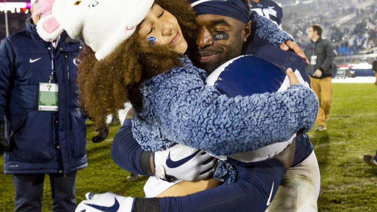 Safety Nick Scott (4) hugs Addy Franklin, head coach James Franklin’s daughter, after the 38-3 win against Maryland at Beaver Stadium on Saturday, Nov. 24, 2018.