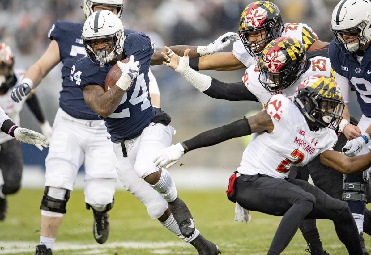 A pack of Maryland defenders reach for Penn State running back Miles Sanders during the game on Saturday, Nov. 24, 2018.