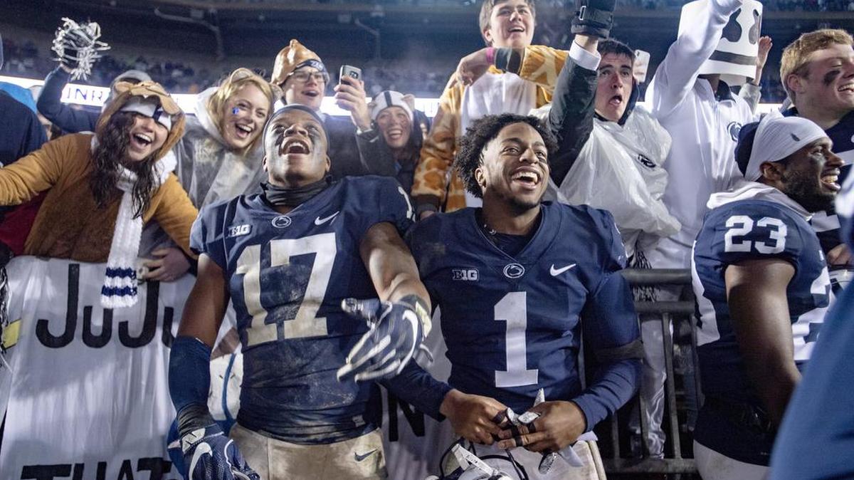 Penn State safety Garrett Taylor and wide receiver KJ Hamler celebrate the 30-24 win over Iowa with the student section on Saturday, Oct. 27, 2018.