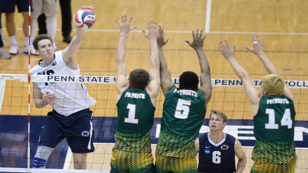 Penn State’s Calvin Mende (left) sends the ball past three George Mason defenders during Saturday night’s match at Rec Hall. (For the CDT/Steve Manuel)