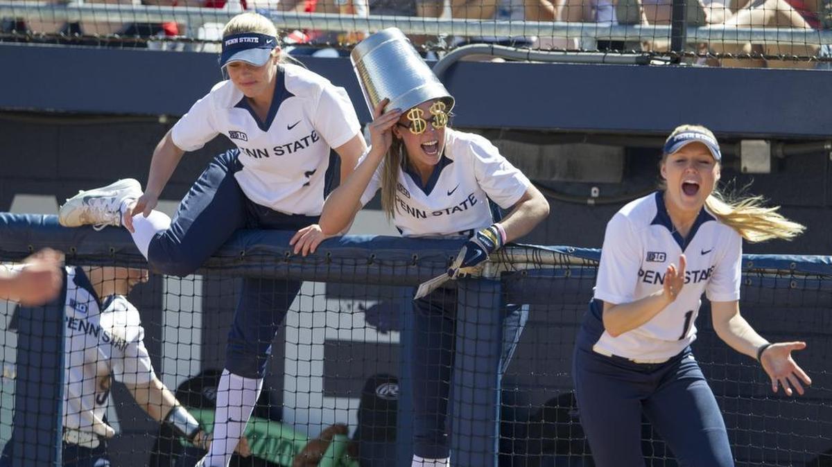 From left, Jessica Haug, Marlaina Laubach and Sam Shanahan climb over the dugout railing to celebrate at the end of Penn State’s 5-3 win over Maryland for a weekend sweep on Sunday at the Nittany Lion Softball Park.