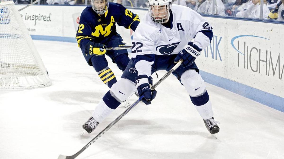 Penn State's David Thompson skates with the puck from Michigan's Cristobal Nieves during the Thursday, January 28, 2016 game at Pegula Ice Arena. Michigan won, 7-4.