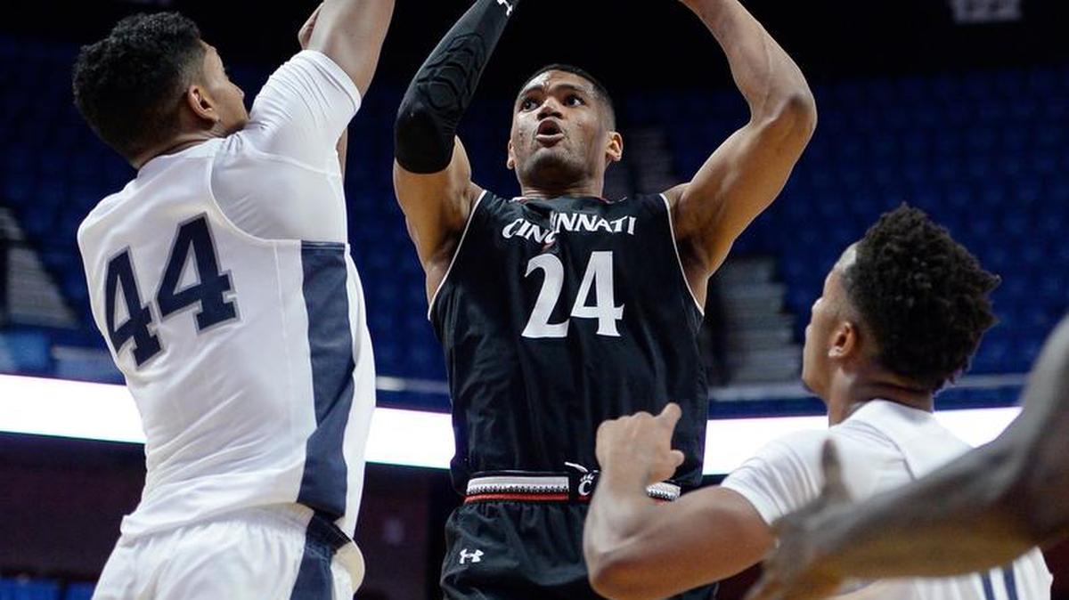 Cincinnati’s Kyle Washington shoots over Penn State’s Julian Moore, left, in the second half of their Hall of Fame Tip-Off Tournament game on Sunday at Mohegan Sun Arena in Uncasville, Conn.