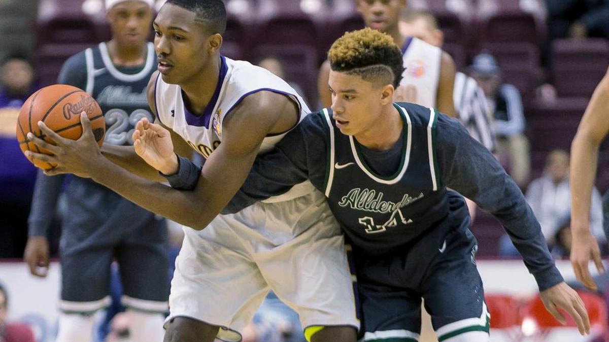 Allderdice’s Timothy Jackson, right, tries to steal the ball from Roman Catholic’s Tony Carr during the PIAA AAAA boys’ basketball championship game at the Giant Center in Hershey on Saturday. Roman Catholic won 73-62. Carr is one of three Penn State recruits.