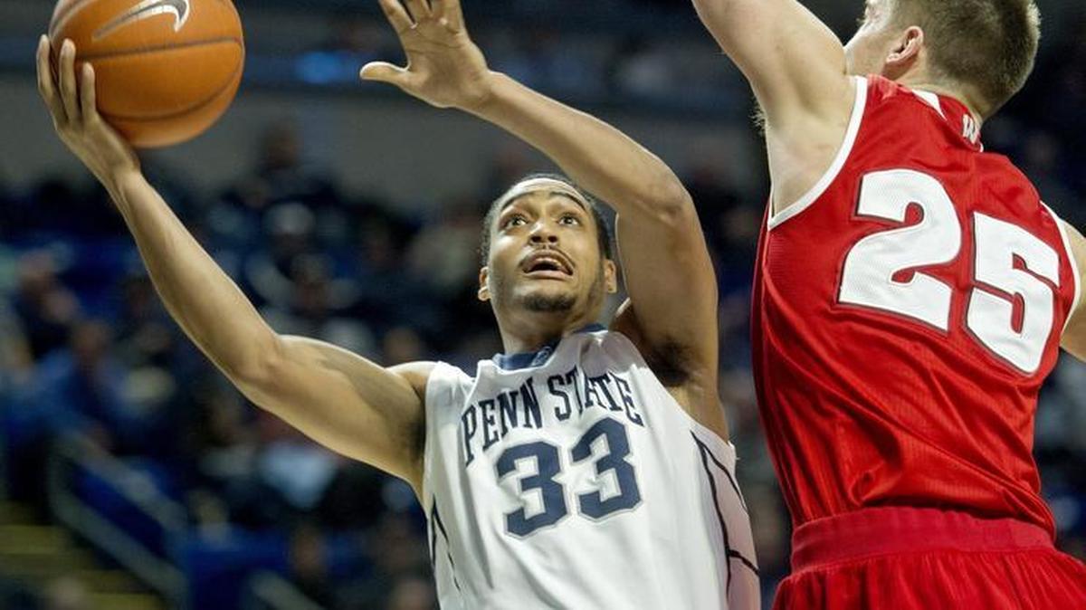 Penn State's Shep Garner goes in for a basket around Wisconsin's Alex Illikainen during the Thursday, January 21, 2016 game at the Bryce Jordan Center. The Badgers won, 66-60.
