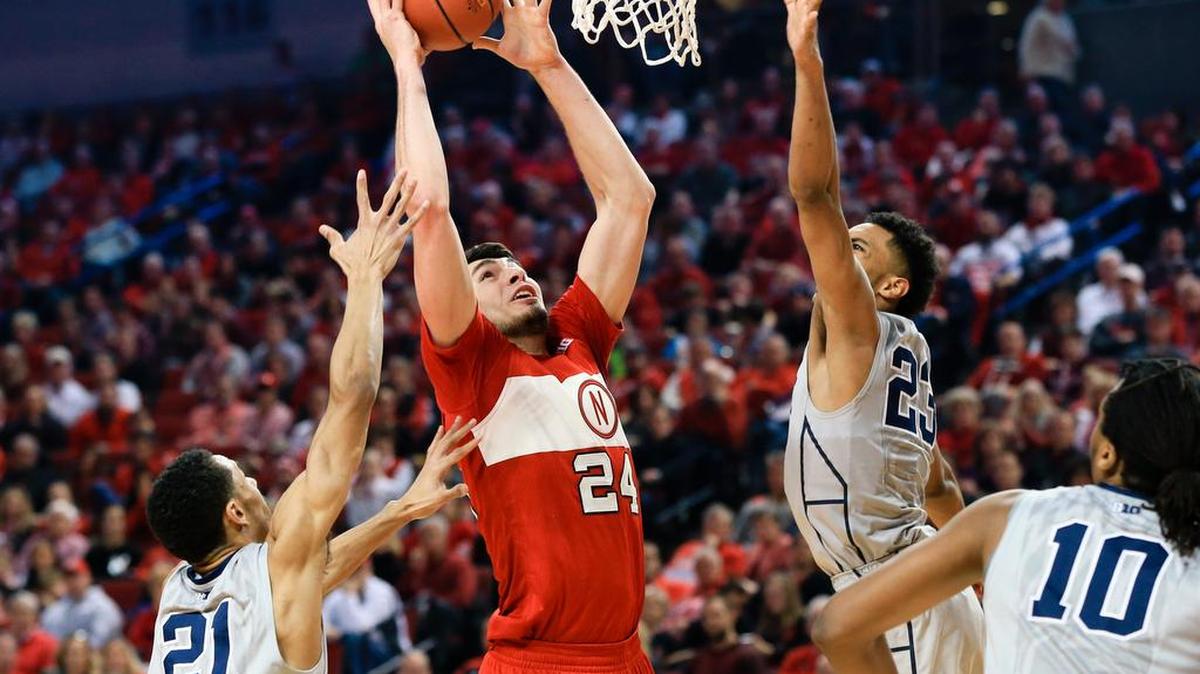 Nebraska’s Jake Hammond (24) shoots a basket between Penn State’s Isaiah Washington (21) and Josh Reaves (23) during Cornhuskers’ 70-54 win over the Nittany Lions.