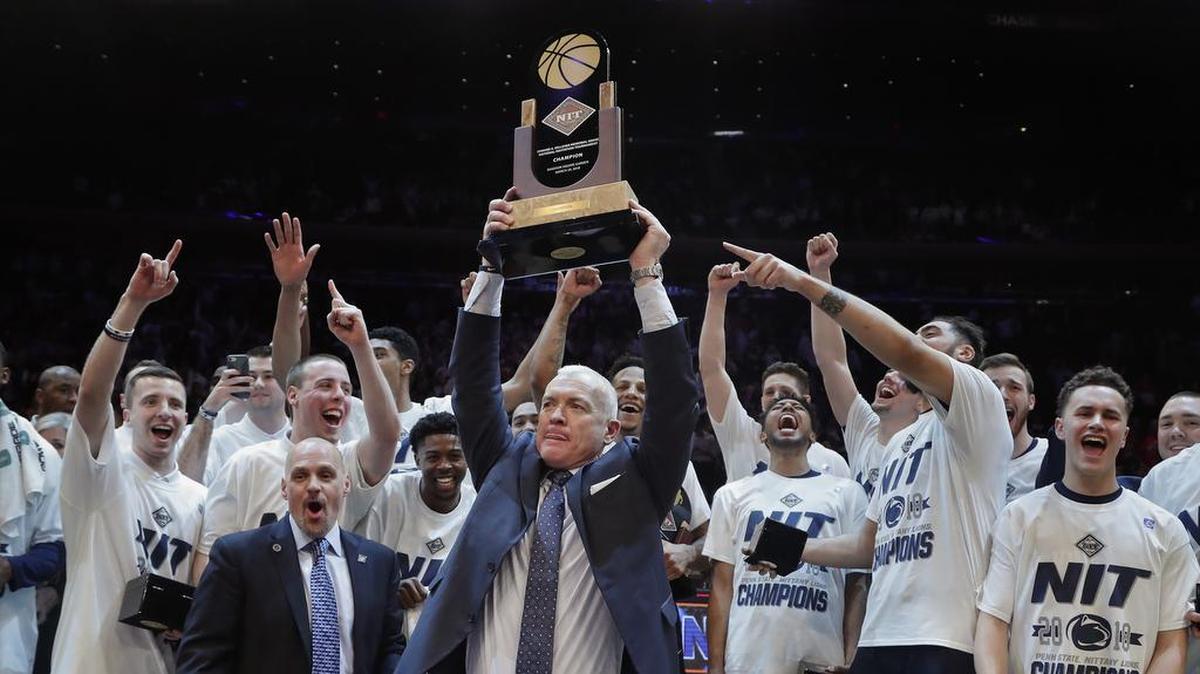 Penn State coach Pat Chambers holds up the NIT championship trophy after Penn State defeated Utah 82-66 in an NCAA college basketball game Thursday, March 29, 2018, in New York.