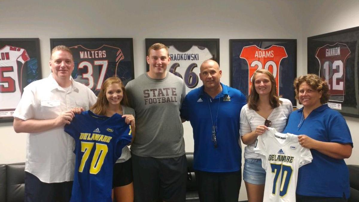 State College senior offensive lineman Robert Nachtman, third from left, poses over the weekend while visiting the University of Delaware — where he committed to play football on Thursday night.
