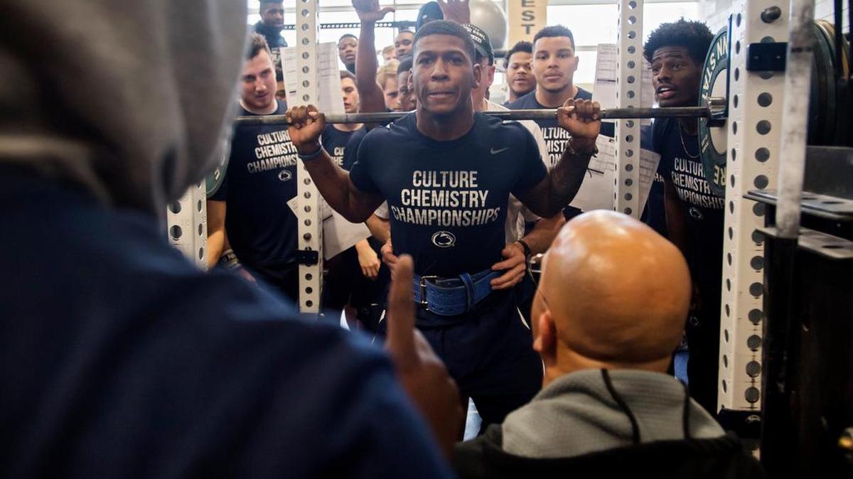 Penn State linebacker Jarvis Miller is encouraged by his teammates and coach James Franklin as he squats during a football winter work out on Wednesday, February 2, 2018.