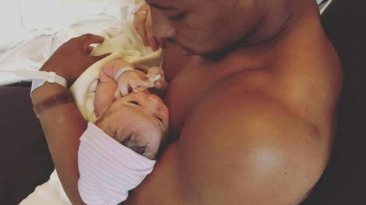Saquon Barkley holds his baby, Jada Clare Barkley.