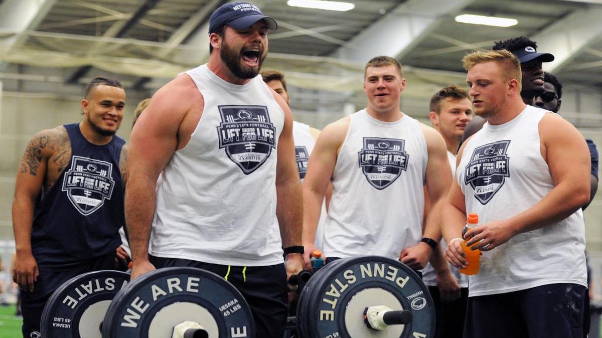 Penn State offensive lineman Michal Menet participates in a weight competition during “Lift for Life” on Saturday at Holuba Hall.