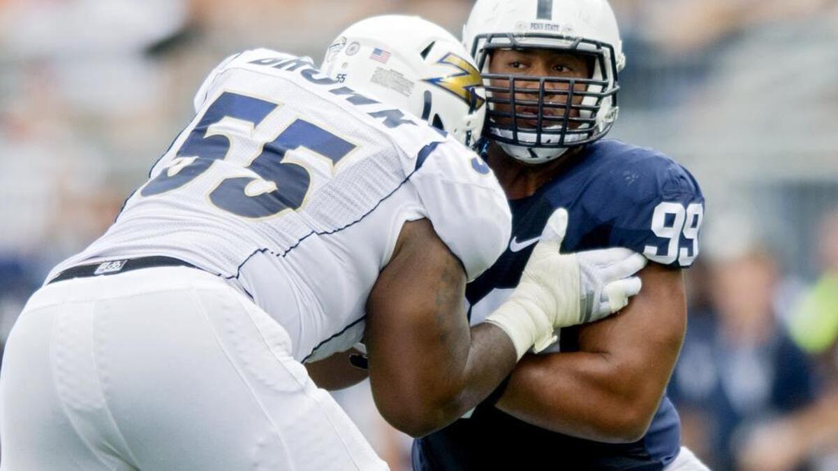 Penn State's Austin Johnson tries to push past Akron's Tommy Brown during the Saturday, September 6, 2014 game at Beaver Stadium. Penn State won, 21-3.