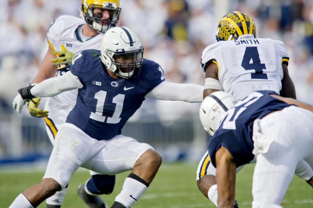 Penn State line back Brandon Bell reaches to stop Michigan’s De’Veon Smith during a November 2015 football game at Beaver Stadium. Michigan won, 28-16.