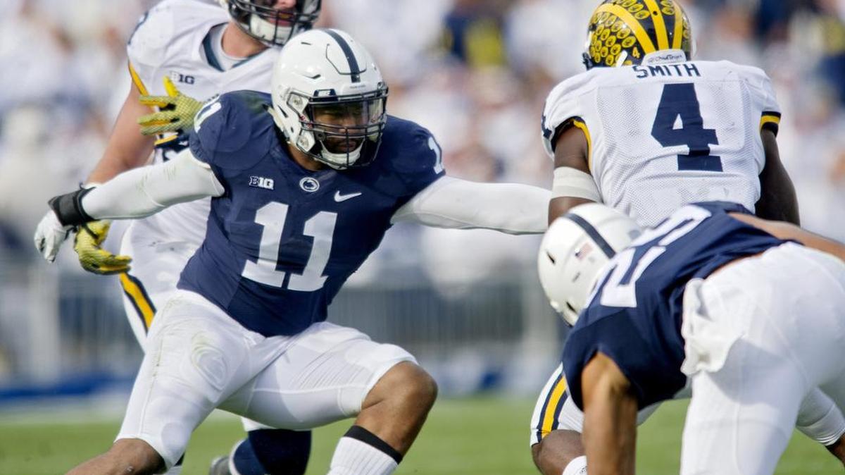 Penn State line back Brandon Bell reaches to stop Michigan’s De’Veon Smith during the Saturday football game at Beaver Stadium. Michigan won, 28-16.