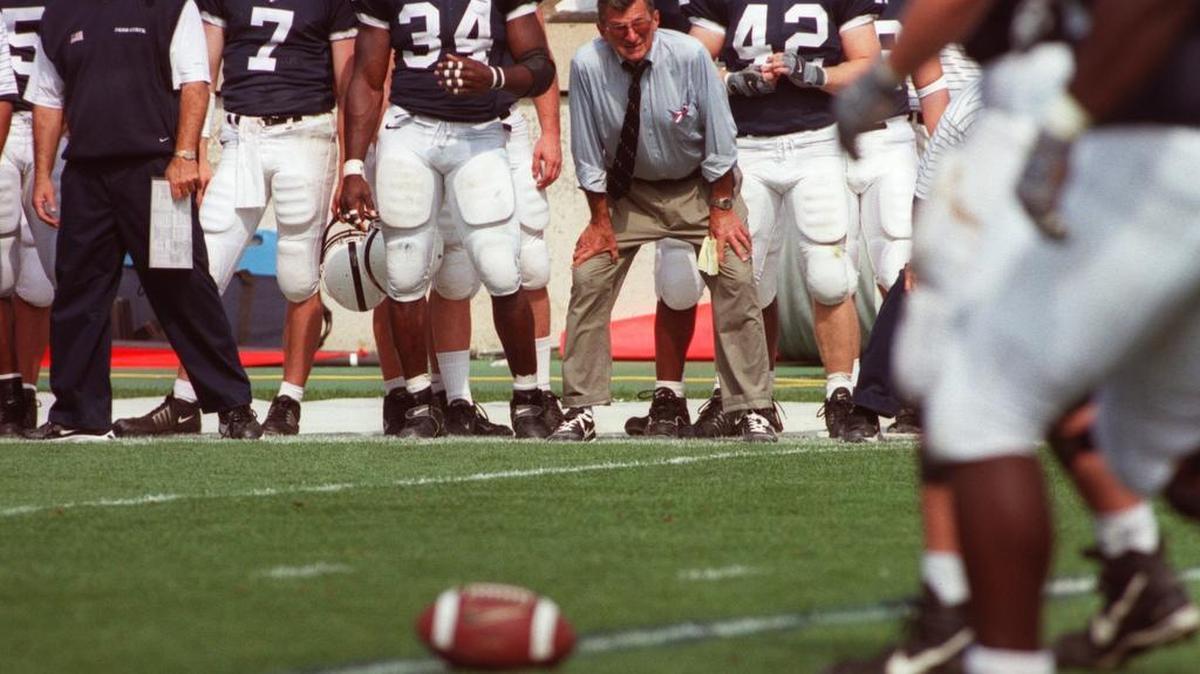 Joe Paterno, Fran Ganter and Penn State players watch from the sidelines during the third quarter of the game against Wisconsin on September 22, 2001.