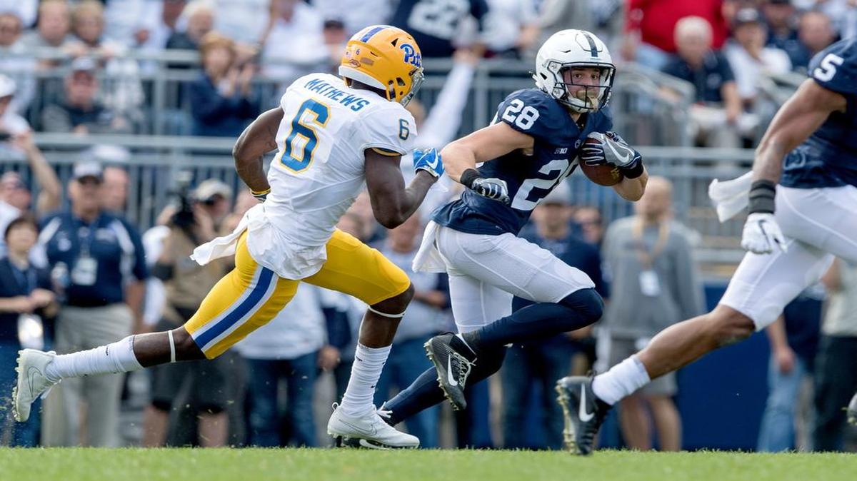 Penn State safety Troy Apke runs from Pitt defenders after intercepting the ball during the game on Saturdayat Beaver Stadium. Penn State won, 33-14.