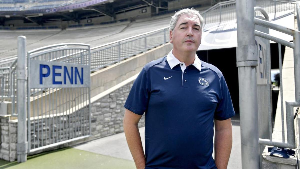 Penn State football offensive coordinator Joe Moorhead stands on the edge of the field during media day.