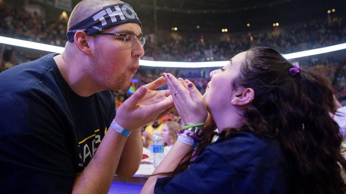 Student Athlete Advisory Board dancers Charlie Shuman and Jessica O’Neill-Lyublinsky pretend to blow fireflies at each other at the end of the line dance on Sunday during the Penn State IFC/Panhellenic Dance Marathon at the Bryce Jordan Center. Shuman is a member of the Penn State football team, and O’Neill-Lyublinsky is a fencer.