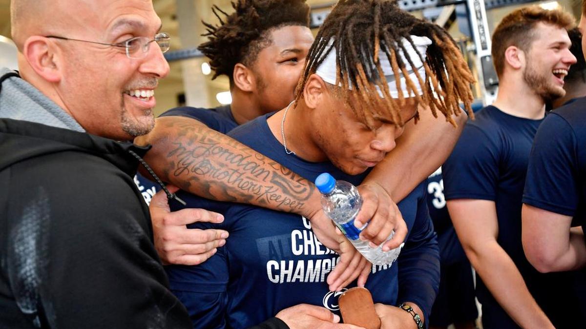Penn State defensive tackle Kevin Givens is congratulated by teammates and coach James Franklin after a football winter workout.