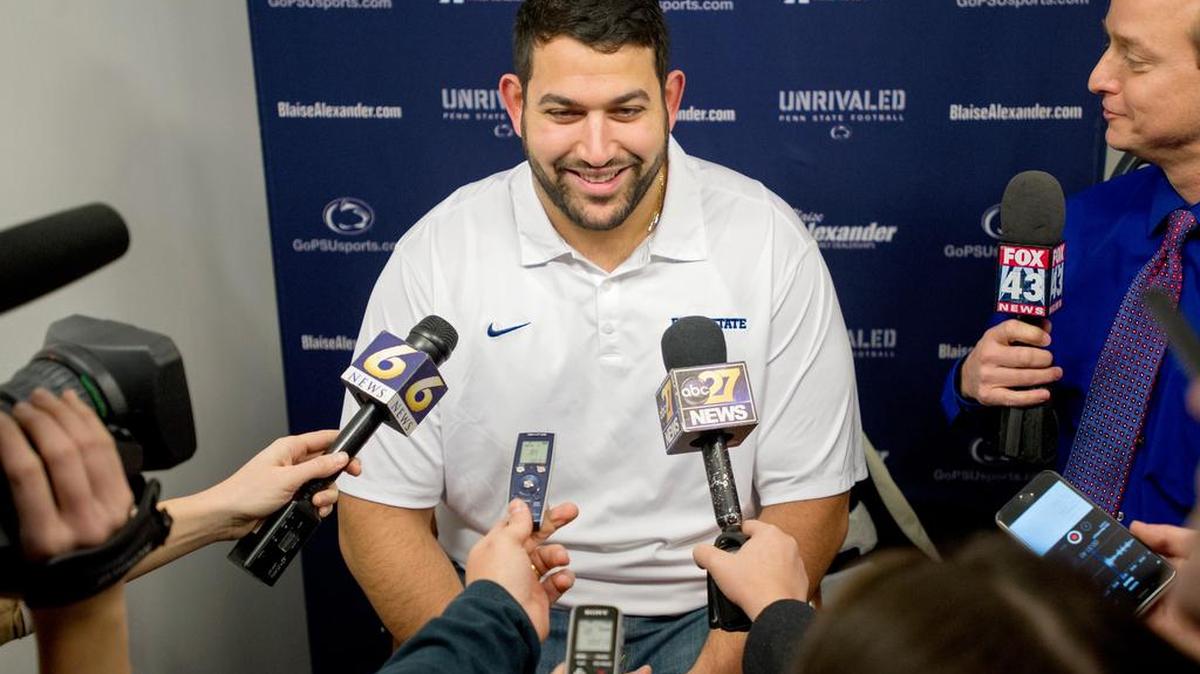 Penn State centre Angelo Mangiro laughs with the media as he talks about graduating with his masters and the upcoming TaxSlayer Bowl during bowl media day at Beaver Stadium on Friday, December 18, 2015.