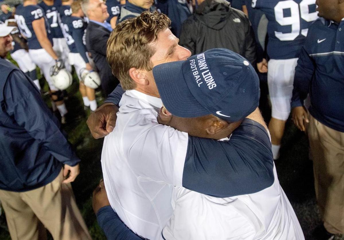Then-Penn State defensive coordinator Brent Pry hugs embraces Sean Spencer after the overtime win over Minnesota on Saturday, October 1, 2016 in Beaver Stadium.