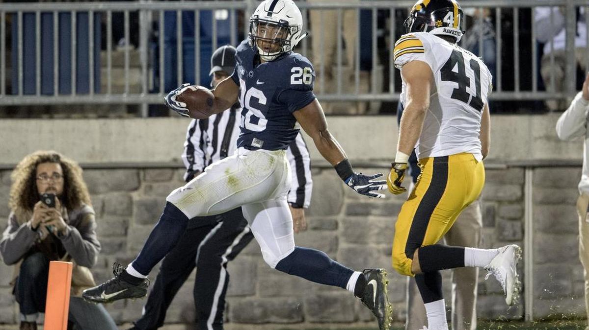 Penn State running back Saquon Barkley glides into the end zone for a touchdown ahead of Iowa linebacker Bo Bower during the Saturday, November 5, 2016 game at Beaver Stadium. Penn State won, 41-14.