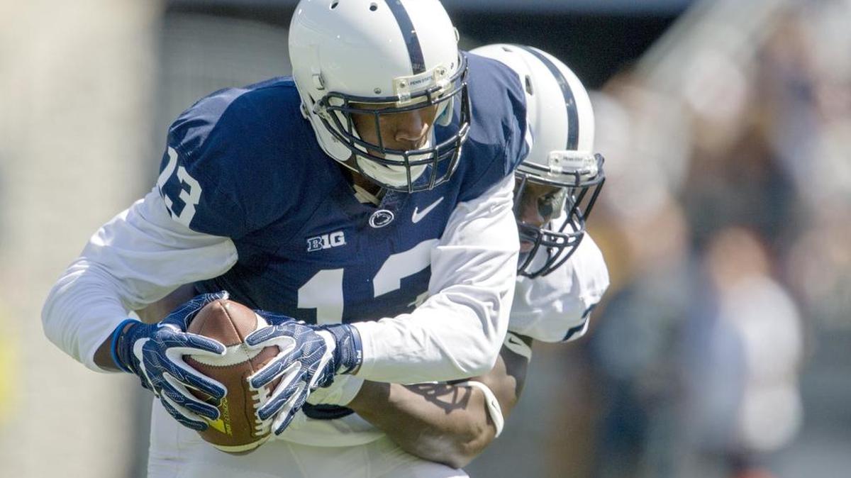 Penn State cornerback Amani Oruwariye tries to pull down Saeed Blacknall during the Blue-White game on Saturday, April 16, 2016 at Beaver Stadium.