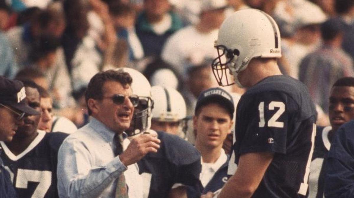 Former Penn State football coach Joe Paterno talks to former quarterback Kerry Collins during a game in October 1993.
