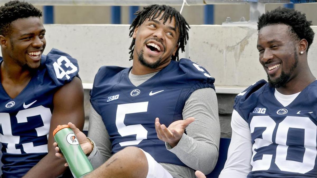 Penn State line backers Manny Bowen, Nyeem Wartman-White and Johnathan Thomas joke around about looking like they're having a ‘hysterical conversation’ as photographers take their photo on Thursday, August 4, 2016 at Beaver Stadium.