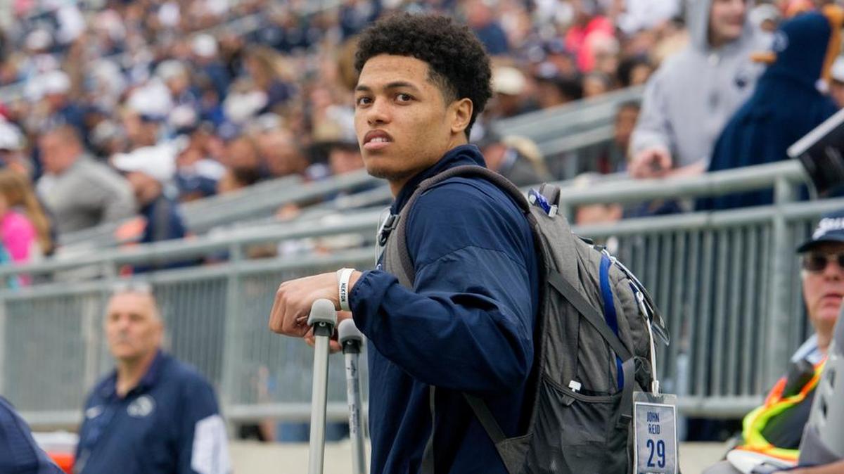 Penn State cornerback John Reid watches from the sidelines with crutches during the Blue-White Game on April 22, 2017 at Beaver Stadium.
