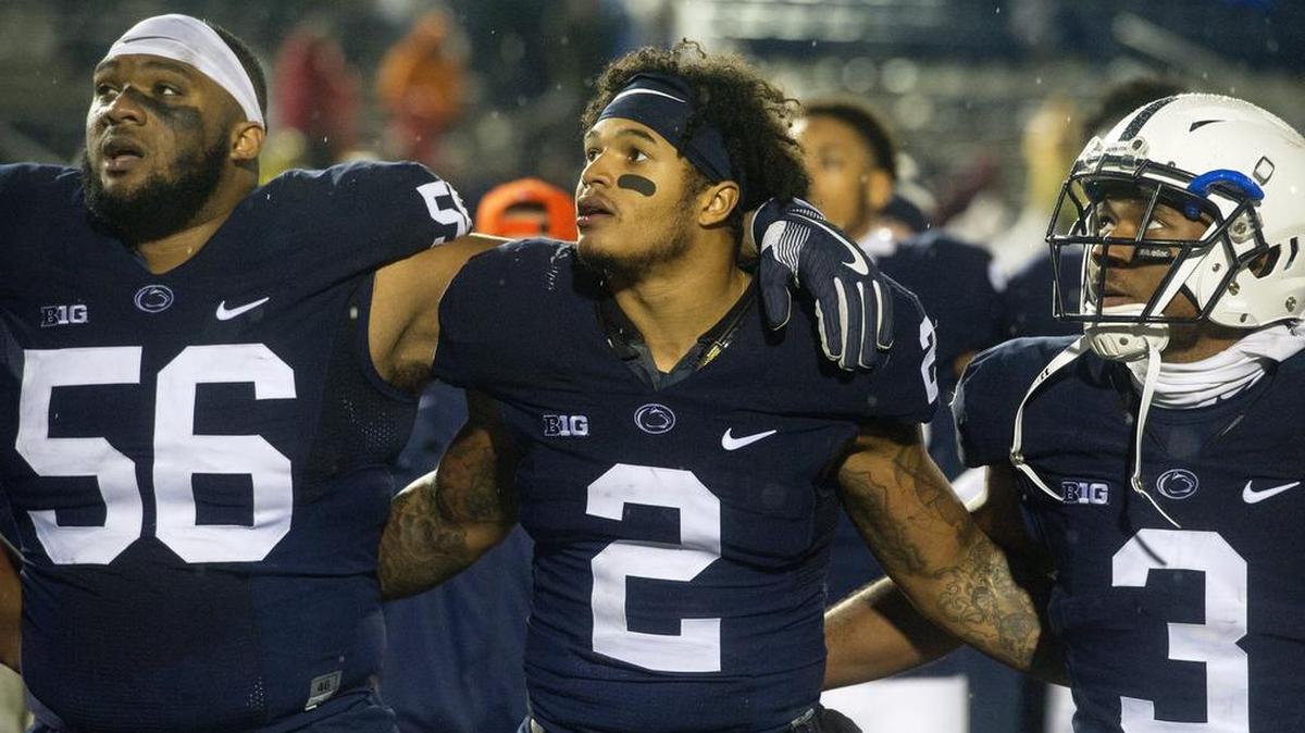 Penn State seniors Tyrell Chavis (56) and Marcus Allen link arms and sing the alma mater Saturday.