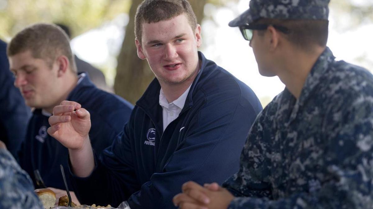 Penn State football tackle Brendan Brosnan chats with service men during the teams visit to the Naval Station Mayport on Wednesday, December 30, 2015, as part of the TaxSlayer Bowl week.