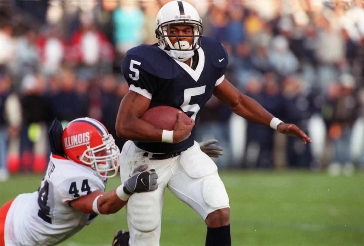Penn State running back #5 Larry Johnson eludes the tackle of Illinois defender #44 Matt Sinclair during the game on November 2, 2002.