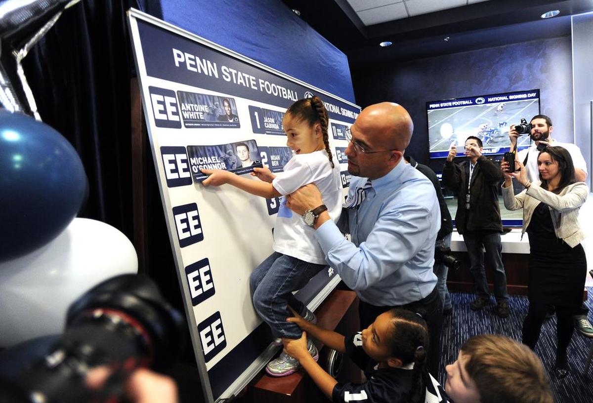 Coach James Franklin holds his daughter Addy up on Feb. 5, 2014, on National Signing Day inside the Lasch Building. 