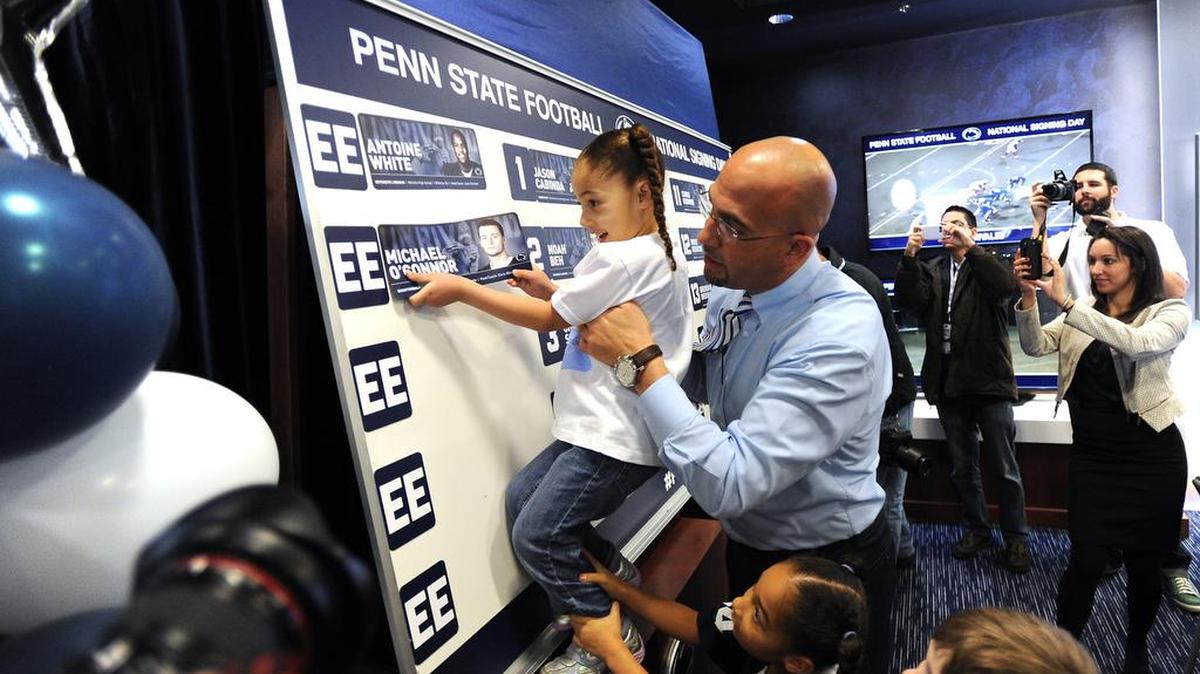 Coach James Franklin holds his daughter Addison up on Feb. 5, 2014, on National Signing Day inside the Lasch building. Franklin brought a new sense of excitement to the day.