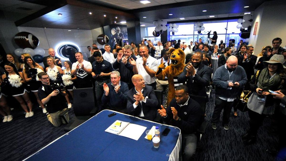 Penn State football head coach James Franklin, center, and the rest of his coaching staff celebrate receiving a letter of intent from a recruit. Wednesday, February 3, 2016 is National signing day where football recruits can officially commit to the school of their choice. Penn State held a recruiting party with a "war room" in the Lasch building on campus in University Park, Pa.