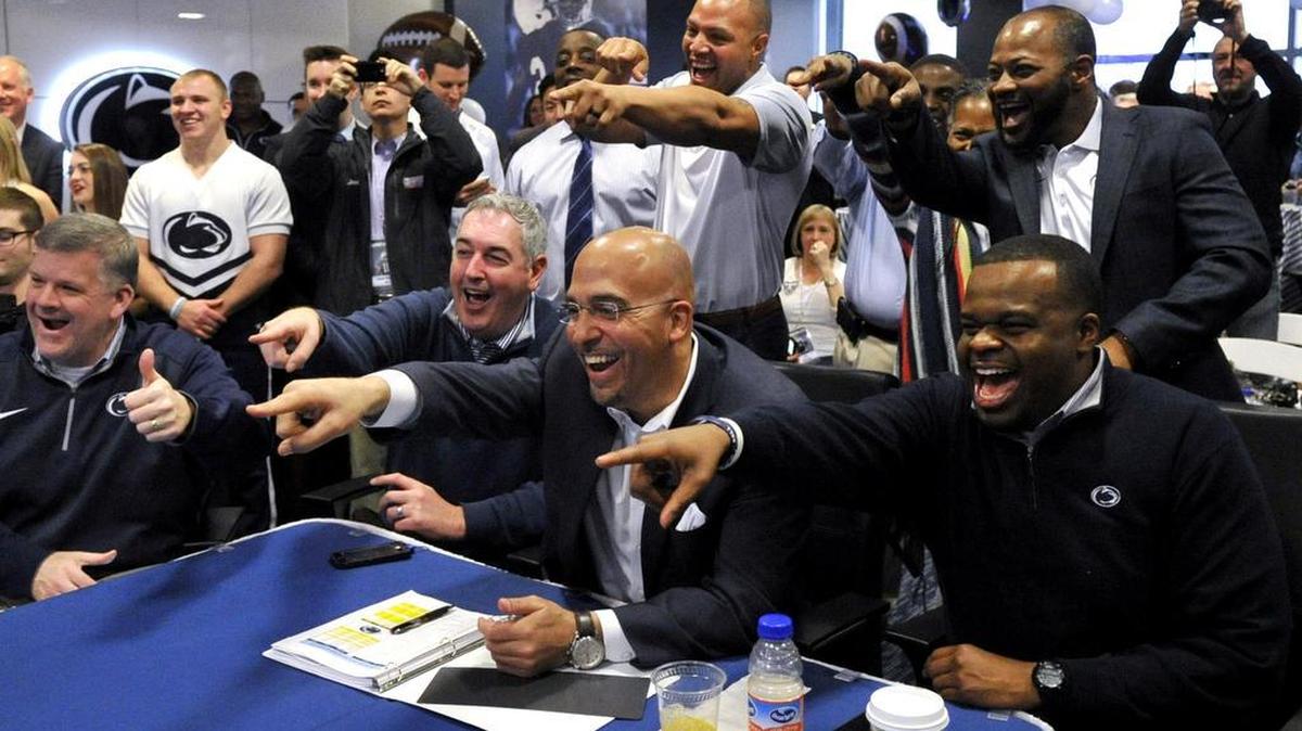 Penn State football head coach James Franklin, middle, offensive coordinator Joe Moorhead, left, and coach Charles Huff, right, as well as coaches Josh Gattis, top middle, and Terry Smith, top right, point and celebrate as they see recruit Miles Sanders on their screen. Wednesday, February 3, 2016 is National signing day where football recruits can officially commit to the school of their choice. Penn State held a recruiting party with a "war room" in the Lasch building on campus in University Park, Pa.