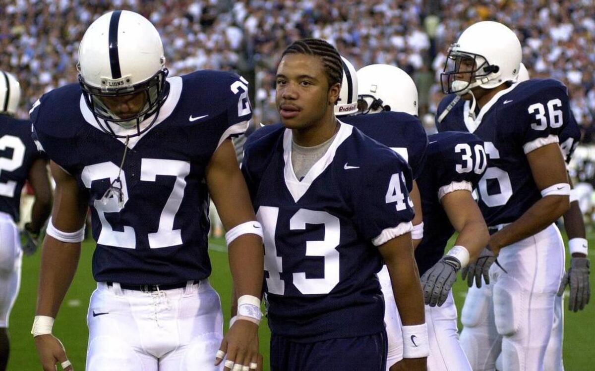 Penn State's Adam Talieferro (43) is welcomed by his teammates after his introduction at Beaver Stadium on Saturday, Sept. 1, 2001 in State College, Pa. Penn State's Chris Harrell (27) walks with him.