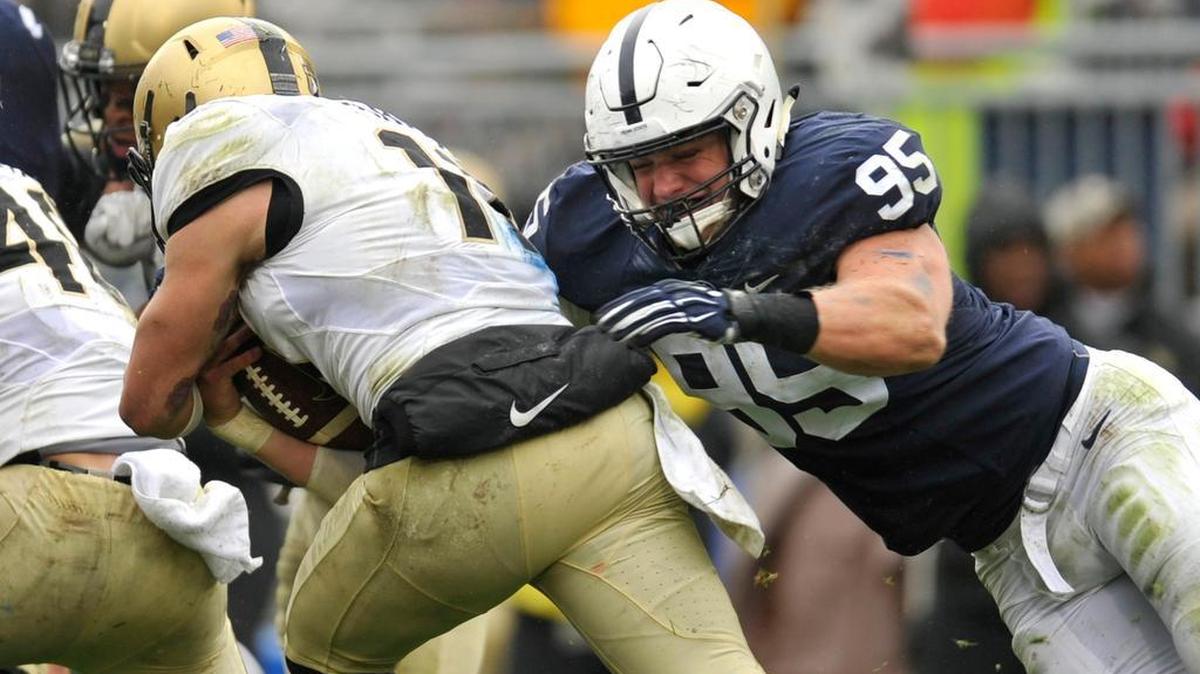 Penn State's Carl Nassib tackles Army quarterback A.J. Schurr for a loss. Penn State beat Army West Point 20-14 at Beaver Stadium October 3, 2015.