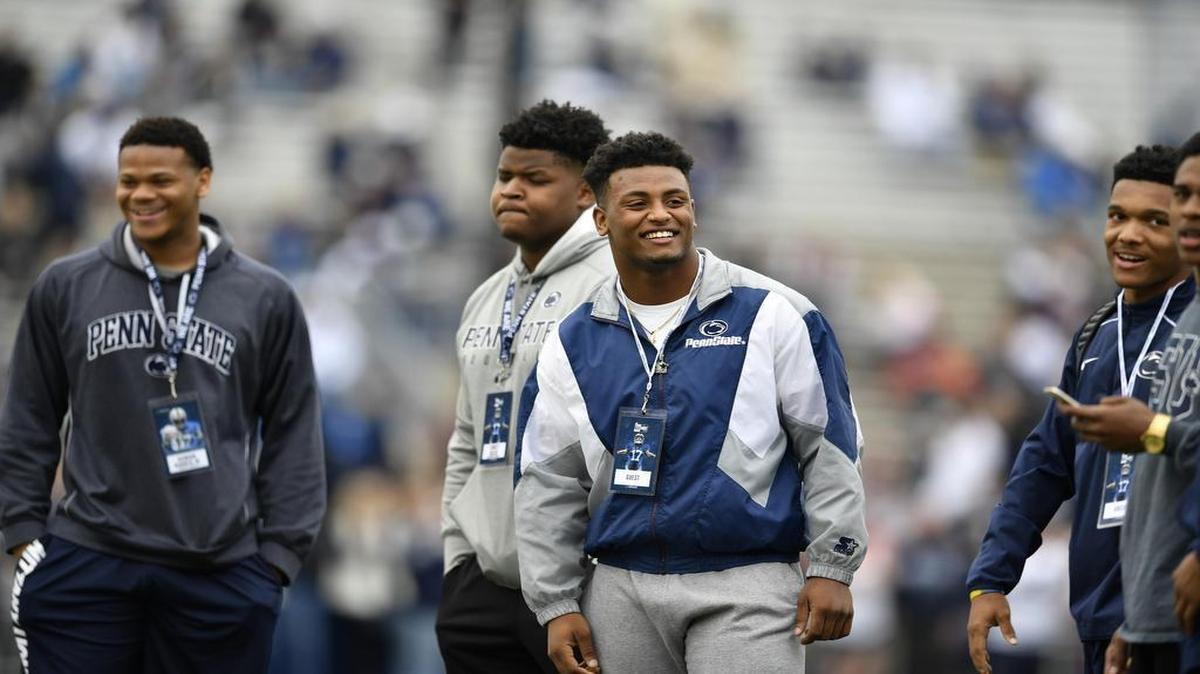 Ellis Brooks, center, an incoming Penn State freshman linebacker, looks to the crowd during the Blue-White game on April 22 at Beaver Stadium. Brooks is a four-star talent, and he was also a Corps of Cadets first lieutenant.