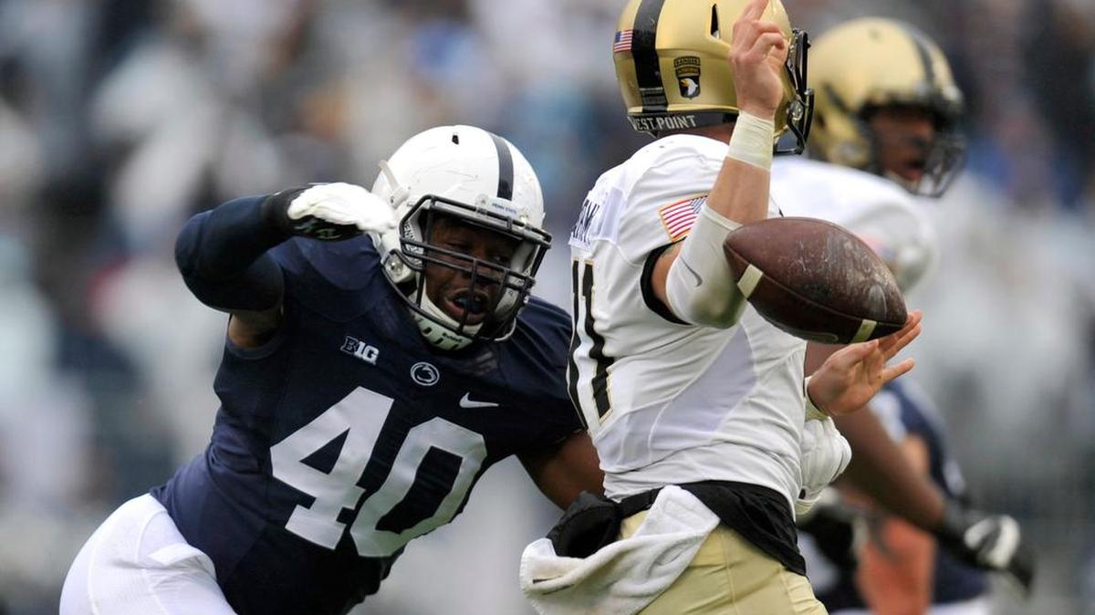 Penn State's Jason Cabinda hits Army's A.J. Schurr as he fumbles the ball. Penn State plays Army West Point at Beaver Stadium October 2, 2015.