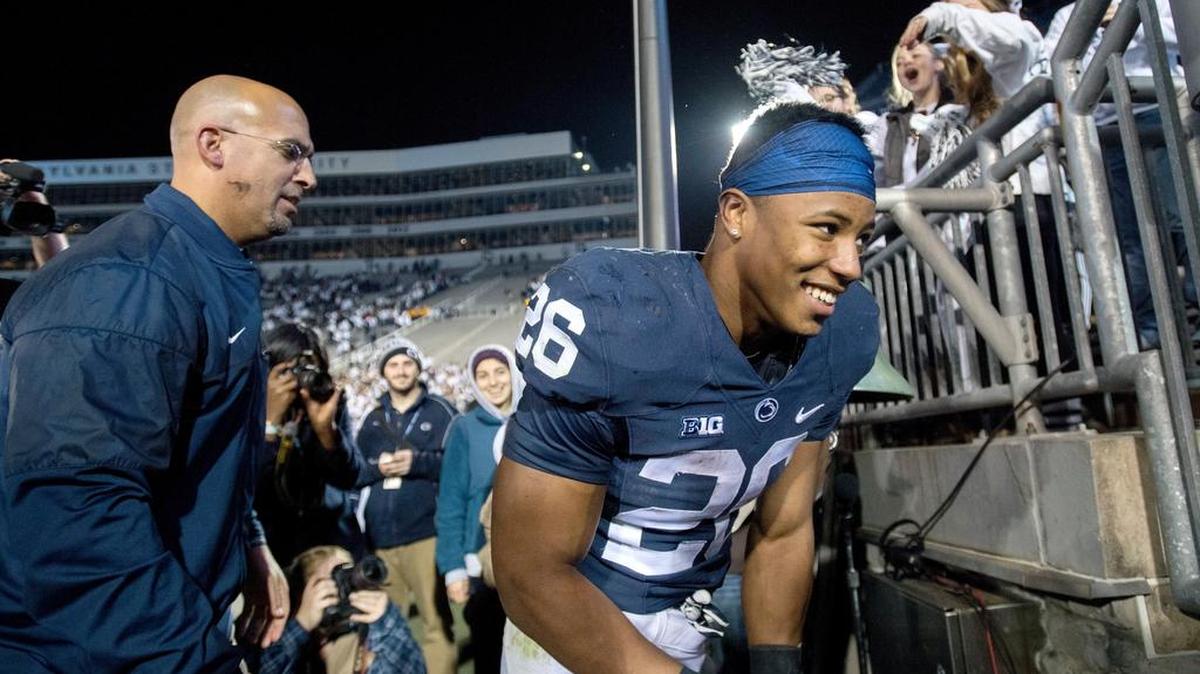 Penn State running back Saquon Barkley rings the victory bell better after the 41-14 win over Iowa on Saturday, November 5, 2016 at Beaver Stadium.